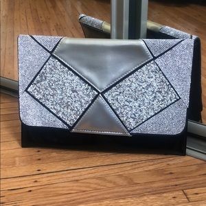 Silver sparkle and black patent clutch